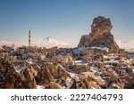 Panoramic view of Ortahisar castle with mosque and old town with a Mount Erciyes in the background at Cappadocia, Turkey.