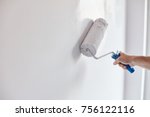 Male Hand Painting Wall With...