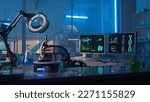 Small photo of Modern medical research laboratory. Empty workplace of a scientist or researcher with computers, microscope, test tubes, flasks and magnifying lamp. Dark biochemical laboratory in the blue light.
