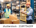 Small photo of Supervisor, manager or boss to angry, scold or mad to worker, employee inside distribution warehouse about bad, damage, broken or dented of cardboard box package. May called carton, parcel, cargo.