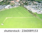 Small photo of Land, landscape of green field in aerial view. Include agriculture farm, house building, village. That real estate or property. Plot of land to housing subdivision, development, sale or investment.