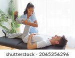 Small photo of A black rehabilitation woman physiotherapy at physio clinic with customer