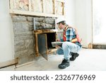 Small photo of An Inspector inspecting an old house to be sure everything is well build