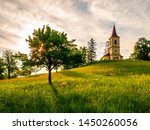Small church in the middle of lush green spring landscape on sunny day. St. Peter and Pauls church at Bysicky near Lazne Belohrad, Czech Republic.
