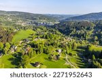 Zdar - part of Tanvald town in the middle of green hills of Jizera mountains on sunny summer day. Czech Republic. Aerial view from drone.