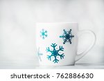 white mug with blue snowflakes... | Shutterstock . vector #762886630