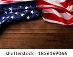 Top view overhead America United States flag, memorial remembrance and thank you of hero, studio shot with copy space on wooden table background, USA holiday Veterans or Independence day concept