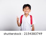 Asian adorable toddler smiling happy wearing student thai uniform red pants show thumb up finger in studio shot isolated on white background, Portrait little children boy preschool, Kid Back to school