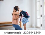 Small photo of Loving mother and schoolgirl with backpack before first day, Asian mother hugging her daughter saying goodbye before go to school at home, parents and child little girl, back to school concept