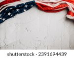Small photo of Vintage American flag for Veteran's Day, symbolizing honor, unity, and pride. Stars, stripes, and government in the USA are integral to patriotic glory. isolated on cement background