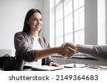 Young business people shaking hands in the office. Handshake, finishing successful meeting. Business etiquette, congratulation, meeting, job interview, new business, startup, employee, teamwork, trust