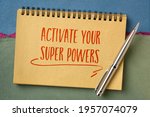 activate your super powers inspirational note - handwriting in a sketchbook against abstract paper landscape, personal development concept