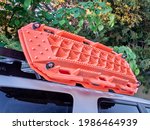 recovery traction ladders mounted on roof racks of suv, used to enhance tire traction in mud, snow or sand emergency conditions