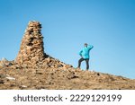 Hiker And Large Stone Cairn...