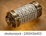 Small photo of aging word as a password to combination puzzle box with rings of letters, cryptography and lifestyle concept