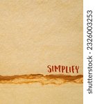 Small photo of simplify reminder, pragmatic, declutter or get organized concept, inspirational handwriting on a handmade paper