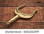 Small photo of brass rowlocks (oarlock) on rustic weathered barn wood background