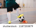 Indoor soccer player training with balls. Indoor soccer sports hall. Football futsal player, ball, futsal floor. Sports background. Futsal league. Indoor football players with classic soccer ball.