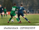Small photo of Two College Soccer Teams Playing Soccer League Game. Adult Soccer Players in a Duel. Two Football Players Competing in a Game. European Soccer Tournament Match For Adult Players.