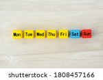 Colorful wooden blocks with omitted day of week words