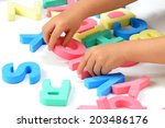 child's hands playing with... | Shutterstock . vector #203486176