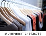 stock-photo-clothes-hang-on-a-shelf-in-a-designer-clothes-store-in-melbourne-australia-146426759.jpg