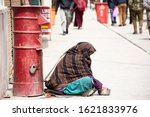 Old indian women beggar or untouchables caste sit and begging money from travelers people in market at Leh Ladakh Village in Jammu Kashmir, India