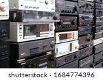 Small photo of WROCLAW, POLAND - JANUARY, 2020. Wall of Retro Audio Devices for Sale on a Flea Market. Stereo Amplifiers, Compact Disc Players, Receivers, Video Cassette recorder, Stereo Cassette Deck