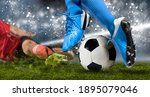 Small photo of Football player man in action on dark arena background. Soccer player making sliding tackle