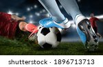 Small photo of Football player man in action on dark arena background. Soccer player making sliding tackle