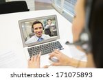 Smiling Businesswoman in the office on video conference, headset, Skype