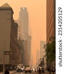 Small photo of New York City, NY - June 7, 2023. A haze over the New York CIty skyline on West 33rd st. as a result of the wildfires in Quebec, Canada.