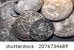Closeup view of medieval European silver coins.Zygmunt III Waza.Ancient silver coins.Numismatics.silver coins covered in dirt.Antikvariat.