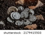 Ancient coin of the Roman Empire.Authentic silver denarius, antoninianus of ancient Rome.Roman silver coins covered in dirt.Antikvariat.