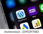 Small photo of WordPress, WooCommerce mobile icon apps on a screen smartphone iPhone closeup. WordPress - open source site content management system. Batumi, Georgia - November 5, 2023