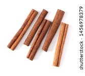 Small photo of Cinnamon sticks isolated on white background closeup. Canella spice. Aromatic condiment background. Flat lay, top view.