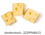Small photo of maasdam cheese cubes isolated on white background close up, top view