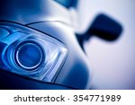 Luxury car Lexus xenon front headlight and mirror a blurry background