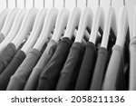 Collection of gray color t-shirts hanging on clothes hanger