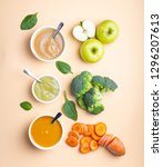 Small photo of White bowls with healthy natural baby food on pastel background. Purees, made of fresh organic fruit and vegetables, flay lay, top view, concept. Kids food made from carrot, broccoli, apples, spinach