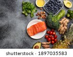 Small photo of Anti inflammatory diet concept. Set of foods that help to reduce inflammation - plant based ingredients, fresh fruit, green vegetables. Healthy diet products, top view, stone background copy space