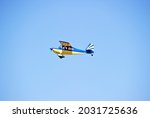 Small photo of TORRANCECALIFORNIA - AUG. 10, 2021: Bellanca 8KCAB fixed wing single engine aircraft is airborne as it departs Zamperini Air Field, Torrance, California USA