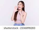 Small photo of Beautiful young Asian woman with open mouths raising hands screaming announcement on isolated white background. Facial and skin care concept for commercial advertising.