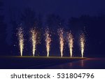 Holidays, celebration concept - many fireworks on ground over evening sky background