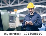 technician engineer standing and checking process on tablet in factory