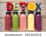 Assorted flavoured smoothie juices in bottles with detox spelt using fruits and vegetables 