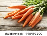 Fresh and sweet carrot on a grey wooden table