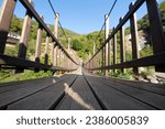 Small photo of Historical wooden suspension bridge. Adventure wooden rope suspension bridge in the rainforest. Wooden suspension bridge leading to the waterfall. Agaran Waterfall. Rize, Turkiye.