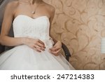 The girl dresses a wedding dress.