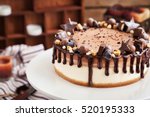 Small photo of Delicious two-ply chocolate cheesecake decorated with candies and frosting